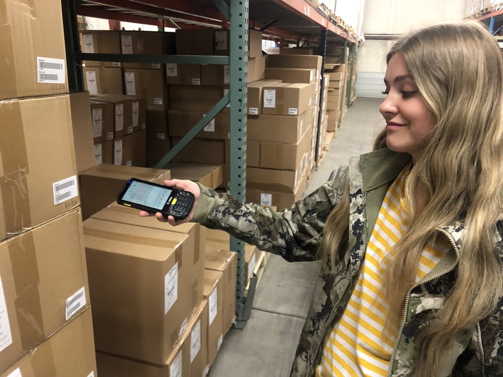 reagan with scanner warehouse worker locating product