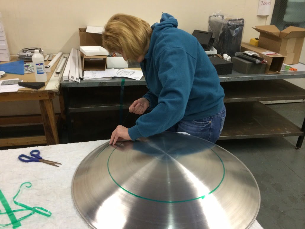 We went back to old-school lathe work to get our shields just right. We made these shields out of aluminum. This shield is being prepped for powder coating to add the red, white and blue.